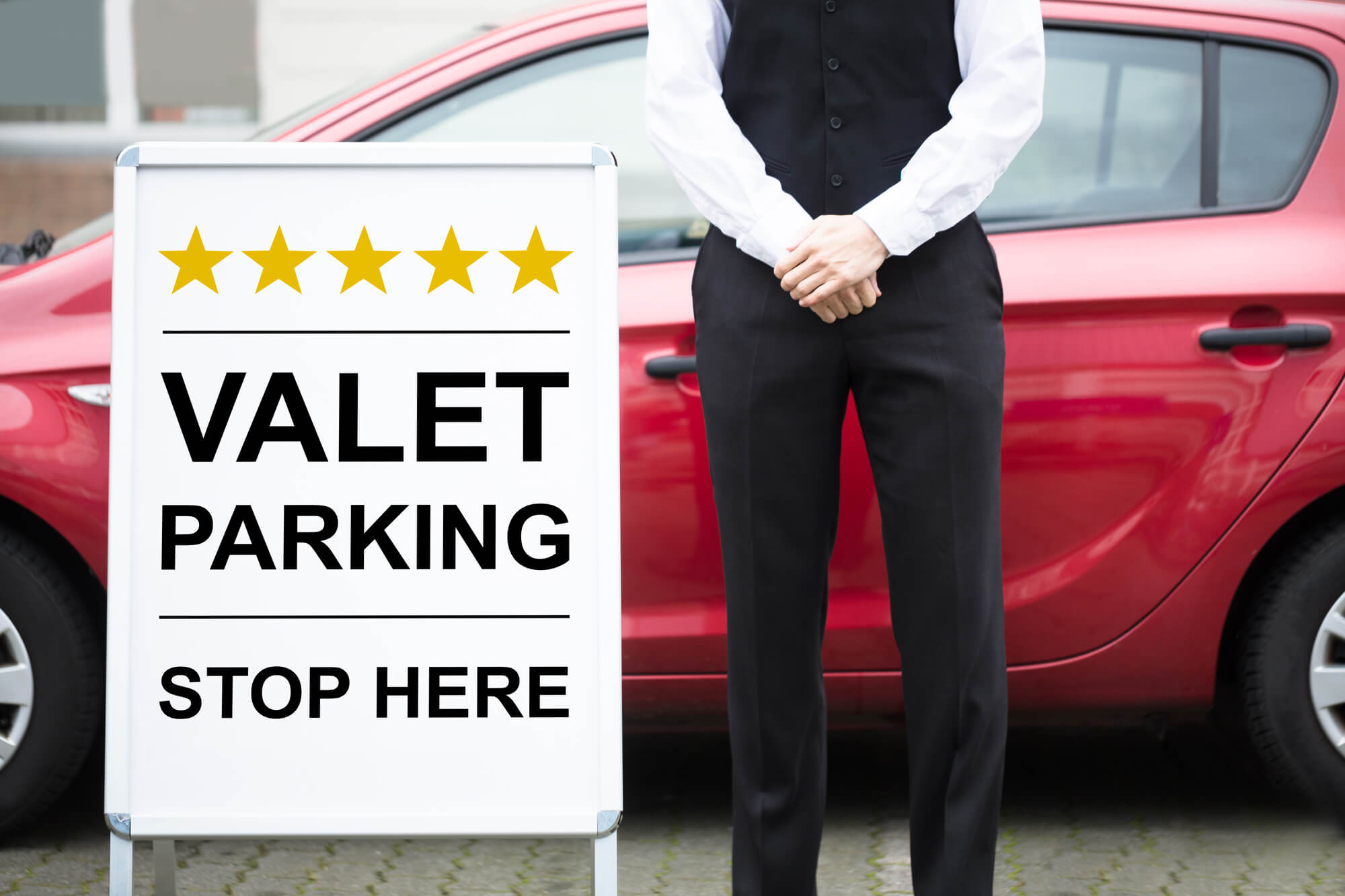 Valet handing car keys to a hotel guest